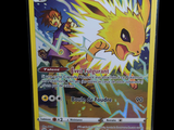 a yellow pokemon card with a picture of a sun and moon
