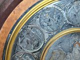 a silver and gold plate with a picture of jesus and angels on it