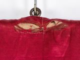 a bird that is sitting in a red bag