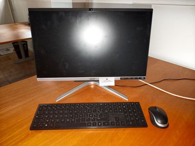 an image of a computer monitor and keyboard on a desk