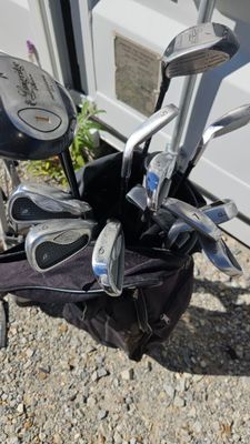 a close up of a golf bag with golf clubs in it