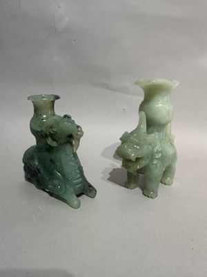 two green vases sitting next to each other on a table