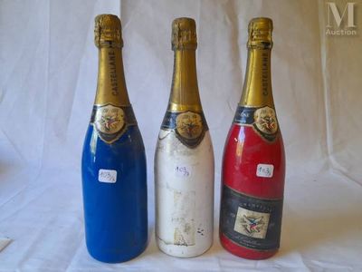 three bottles of wine are lined up on a white surface