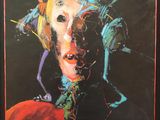 a painting of a woman ' s face is shown in a black frame