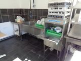 a kitchen with a sink, microwave, and other appliances in it