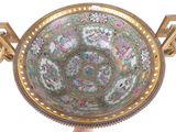 a large bowl with a gold rim and a floral design on it