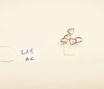 a small ring with a heart on it next to a smaller ring with a heart on it