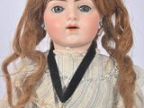 an image of a doll with long red hair wearing a white dress