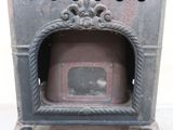 an old fashioned stove with a door in the middle