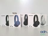 three boxes of sony headphones sitting on top of a table