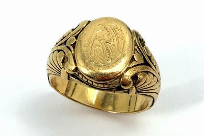 an image of a gold ring with a coin in the center