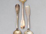 three silver spoons and a silver spoon on a gray surface