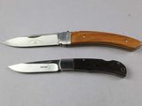 two knives that are sitting next to each other on a table
