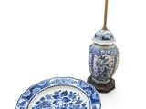 a blue and white plate and a lamp on a table