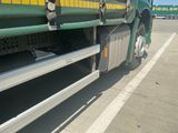 a large green truck parked in a parking lot