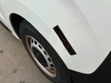 a close up of a white truck with a sticker on it ' s side