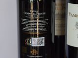 two bottles of wine sitting next to each other on a table