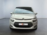 the front of a silver citrole parked in a white room