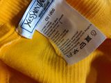 a close up of a yellow shirt with a label on it