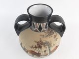 a black and white vase with a painting on it