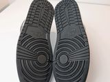 the soles of a pair of black shoes on a white surface