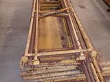 several pieces of wood are stacked on top of each other in a warehouse