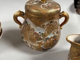 several different types of vases and bowls on a white surface
