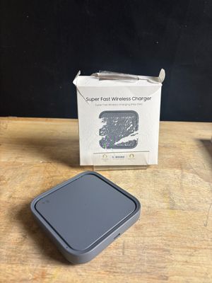an apple wireless charger sitting on top of a wooden table next to a box