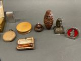 a table with various items on it including an owl, a vase, and other items