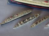three model ships sitting next to each other on a table