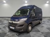the blue van is parked on a checkered floor in the garage