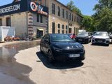 a black car parked in front of a building in a parking lot