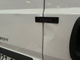 a close up of a car door with a sticker on it