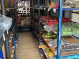 many shelves of fruits and vegetables in the store