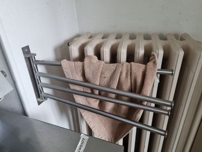 a towel rack with towels hanging on it in a bathroom