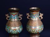 two vases that are sitting side by side on a blue background