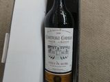 a bottle of wine sitting in a box on the floor