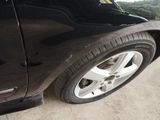 a close up of a black car with a flat tire