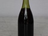 a bottle of wine sitting on a counter top