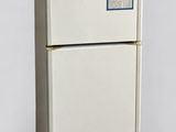 a white refrigerator with a blue sticker on it