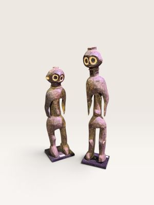 deux figurines en bois représentant un homme et une femme debout l'un à côté de l'autre