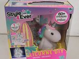 a box with a toy unicorn in it on a table