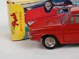 a toy car that is sitting next to a box