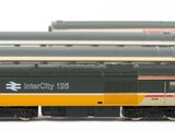 many trains that are lined up together on the tracks