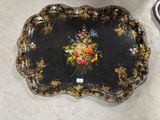un plateau noir orné d'une peinture représentant des fleurs