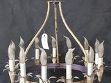 an image of a chandelier with five candles and a bird on it