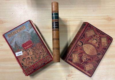 two books and a cigar sitting on a table next to each other