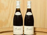 deux bouteilles de vin posées l'une à côté de l'autre sur un tonneau