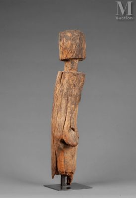 a wooden sculpture of a man with a hat on his head