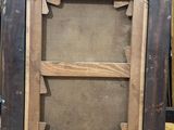 an old picture frame is sitting on a wooden floor in a room
